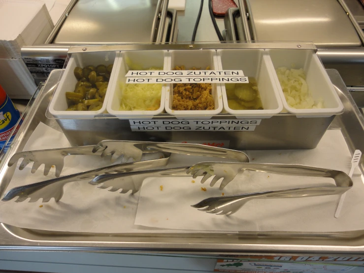 fork, bowl of salad, and small container with potatoes and meats