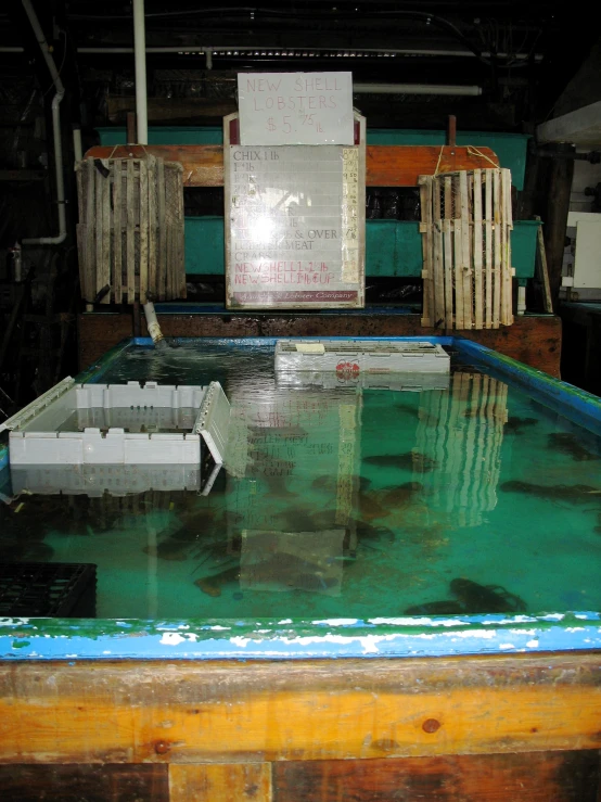 a machine is setting up to prepare an exhibit of large, rectangular boxes