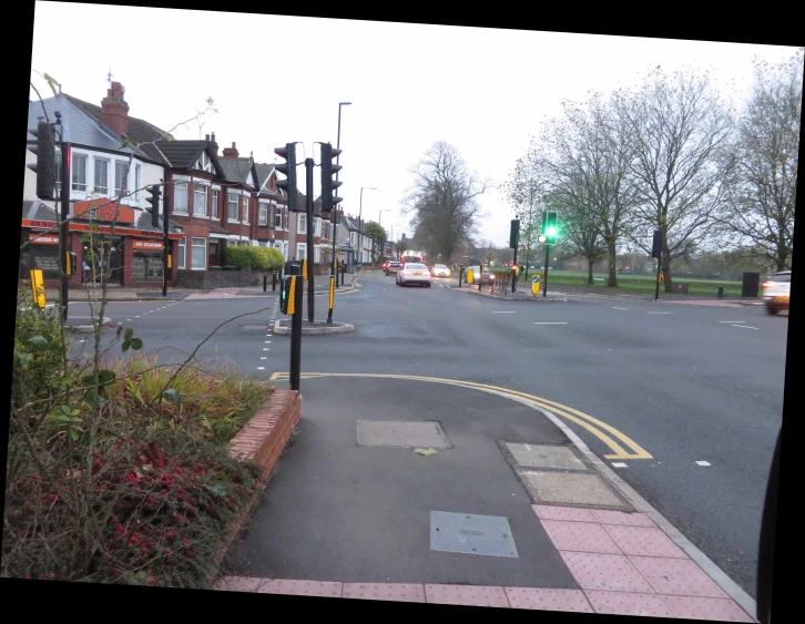 the road has two lanes and cars driving along it