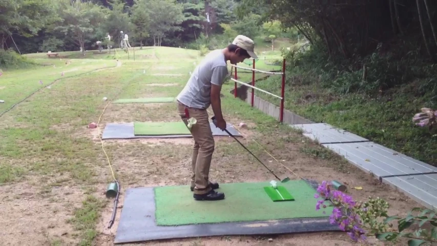 a man on a course with a golf club