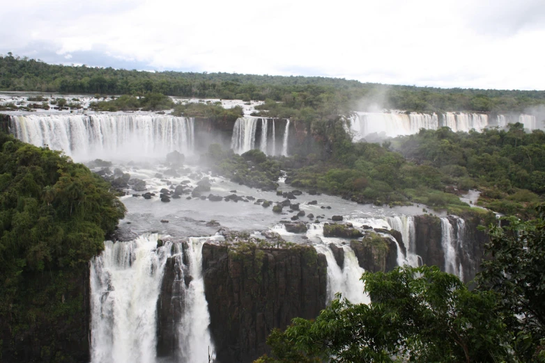 waterfall with river below and trees surrounding