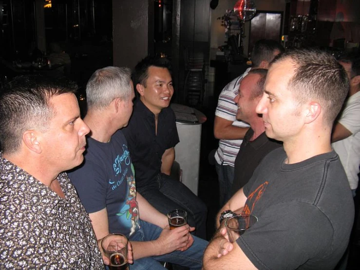 group of people sitting in a bar drinking drinks