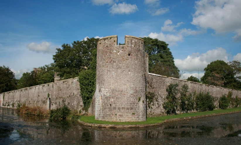 there is a stone structure with two stories and windows on it