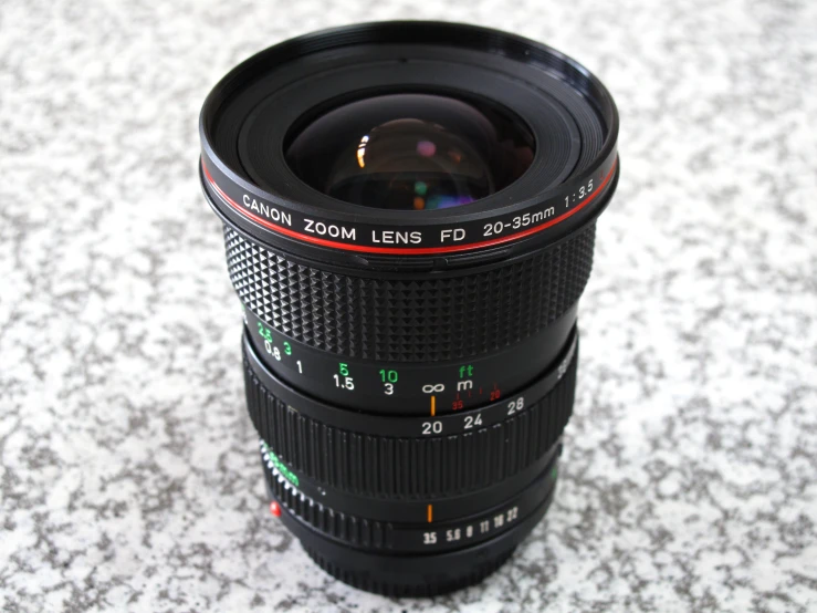 a camera lens sitting on the ground on top of a counter