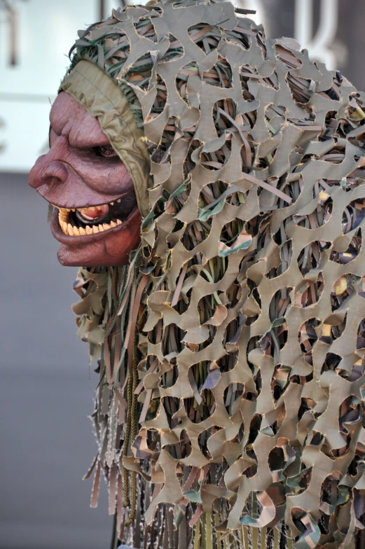 a costume made out of several strips of sheet music with a mask