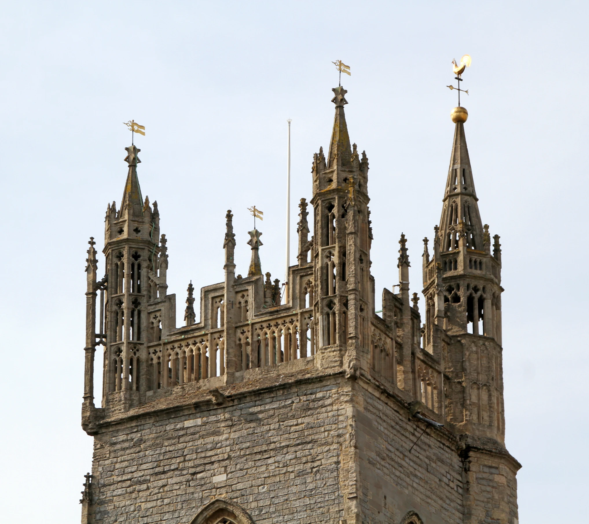a tall clock tower with spires and flags