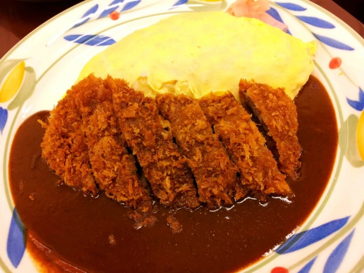 a small piece of fried meat and gravy with mashed potatoes