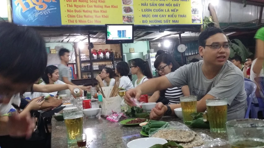 people sitting at the bar and eating food