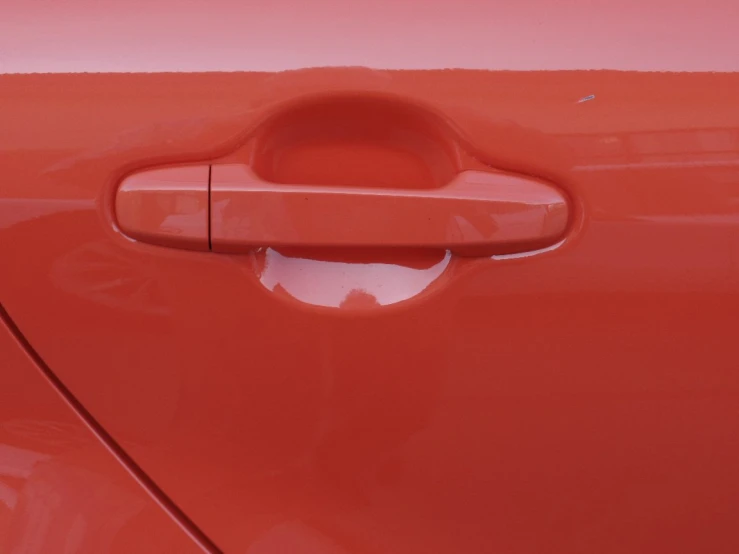 a car with a close up image of a door handle