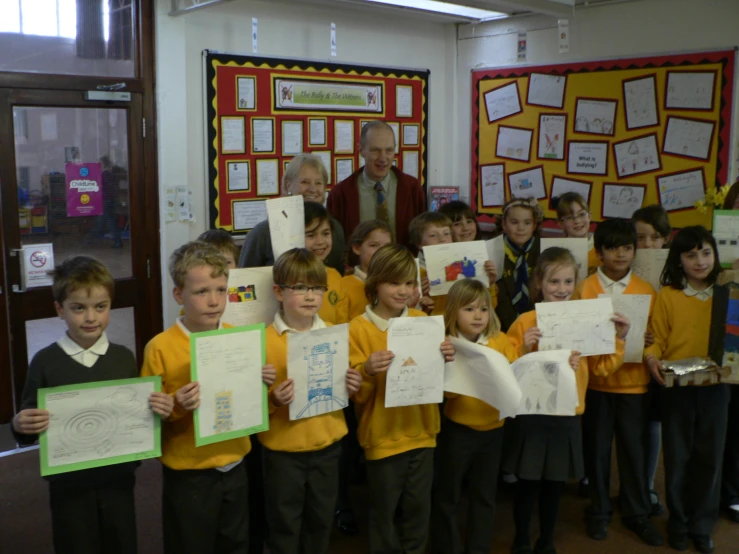 a group of school children holding their boards