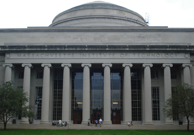 a grey and white building is pictured during the day