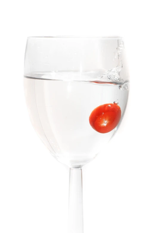 a glass filled with a liquid and some oranges in it