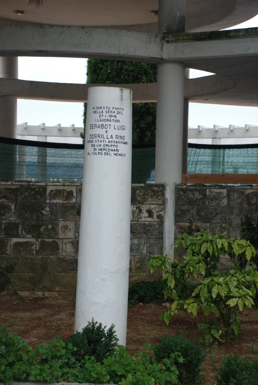 a sign near a fence with words written on it