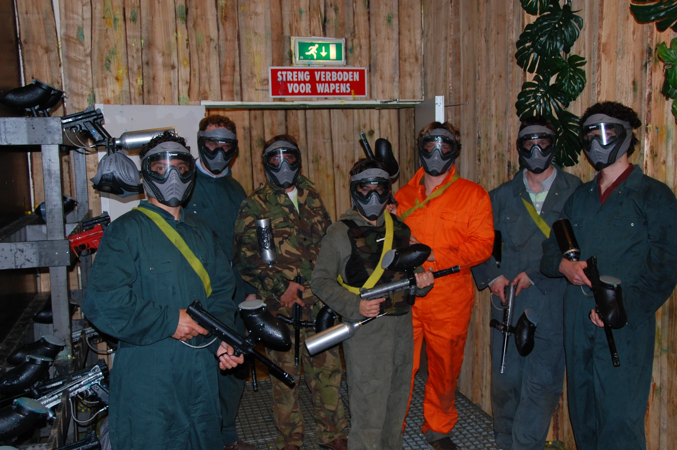 the group of men wearing maskes and holding their weapons pose for a picture