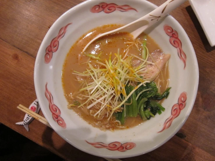 an assortment of food on a plate and chopsticks