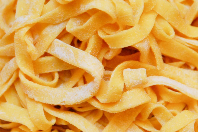 a pile of yellow noodles that are very close to the camera