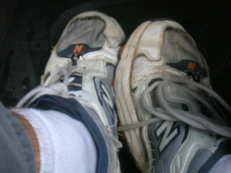 the bottom view of a pair of shoes with one's shoe laces