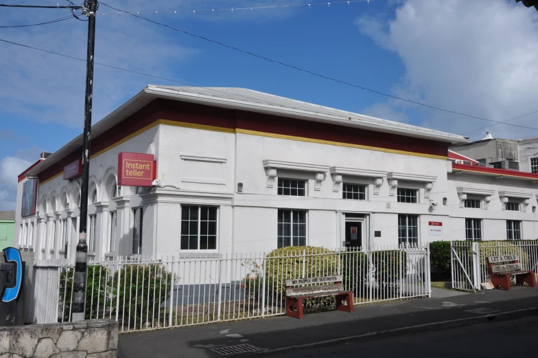 an older building on a street corner with a fence