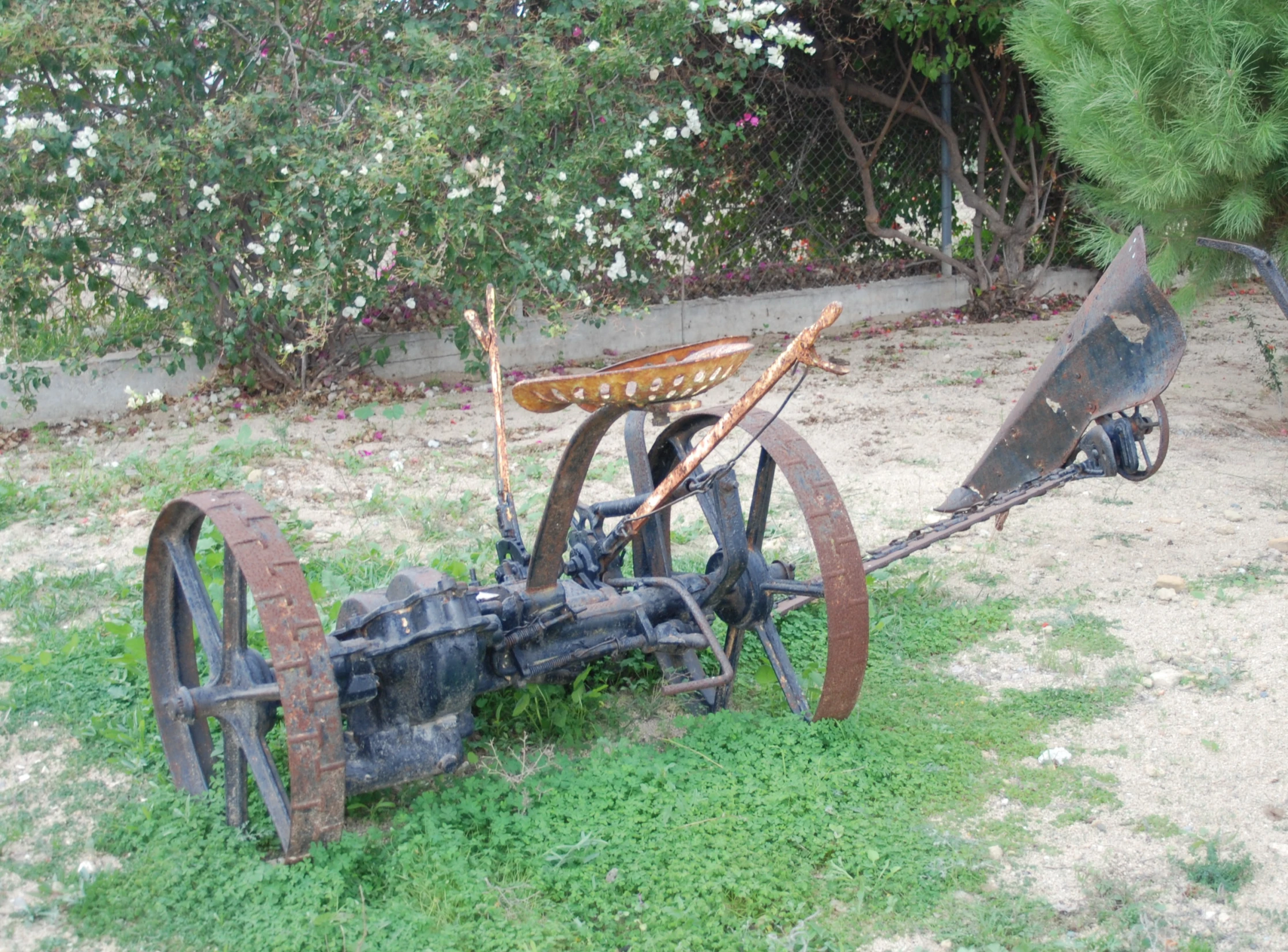 an old rusty tractor sitting in the middle of the field