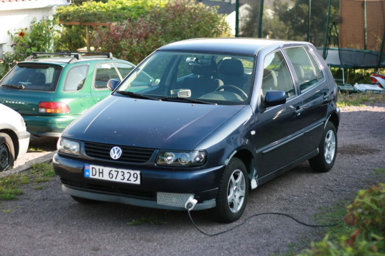 a black car is parked near two other cars