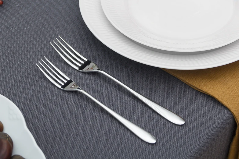 some silverware is set on the table with a bowl and spoon