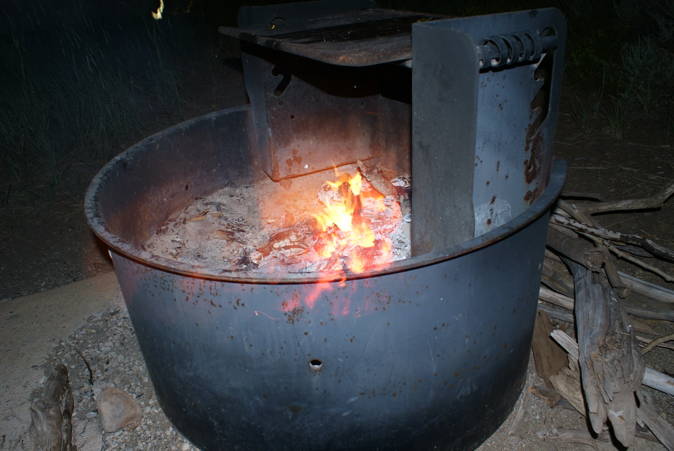 an old metal bowl is being used for cooking