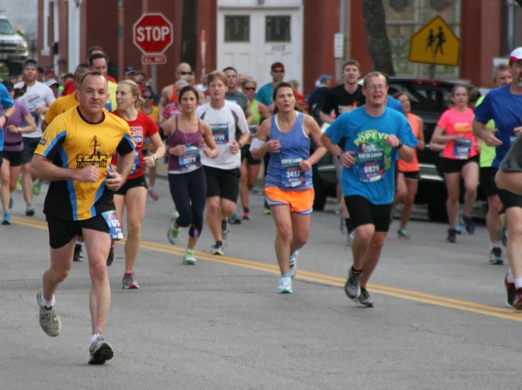 a group of people run in the street