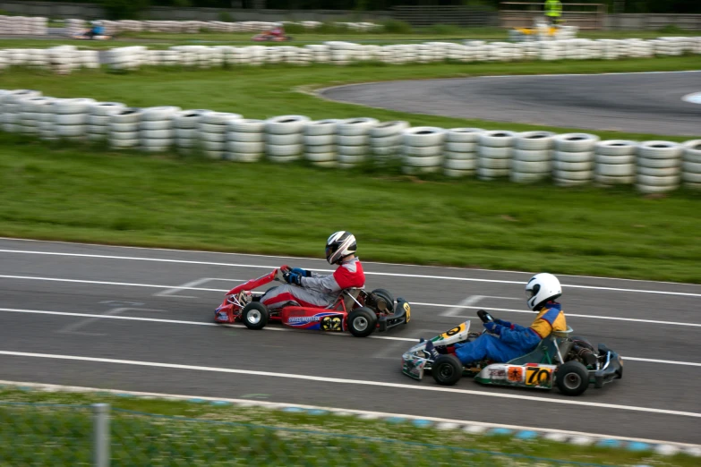 two people driving go kart cars during a race