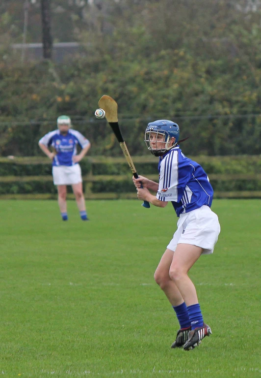 boys in uniforms play a game of lacrosse