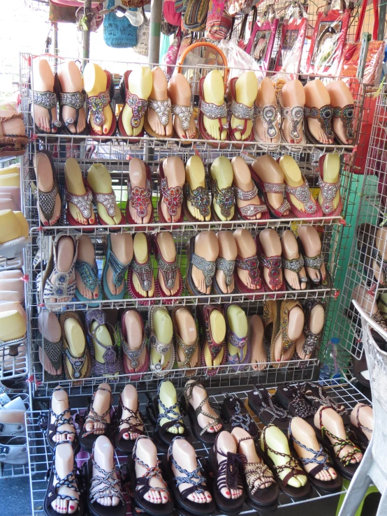 shelves full of sandals and other shoes are on sale