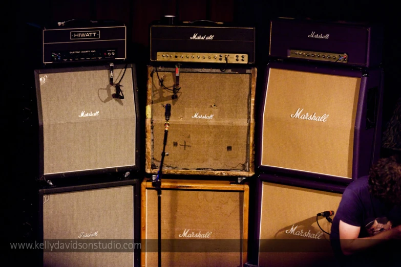 a guy laying his head down in between two guitar amps