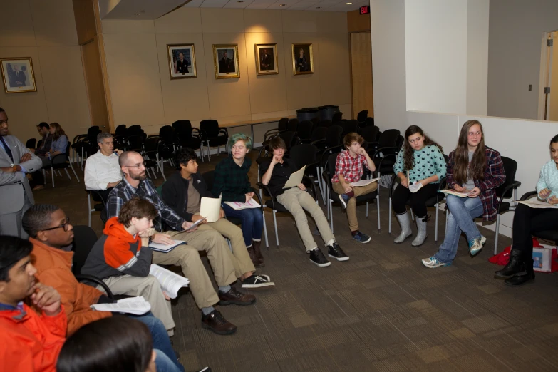 an audience is watching the presentation in a conference room