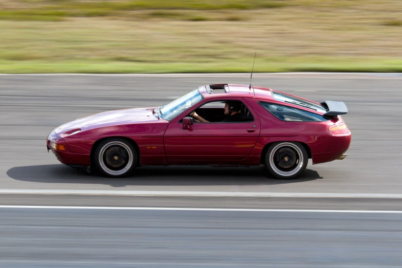 the car is driving along the track on the grass