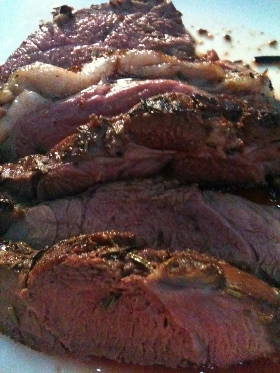 a piece of cooked meat on top of a white plate