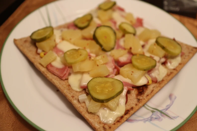 a white plate topped with a cut in half sandwich and vegetables