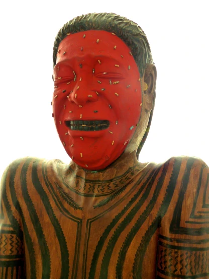 a man with a red painted face stands with his mouth open