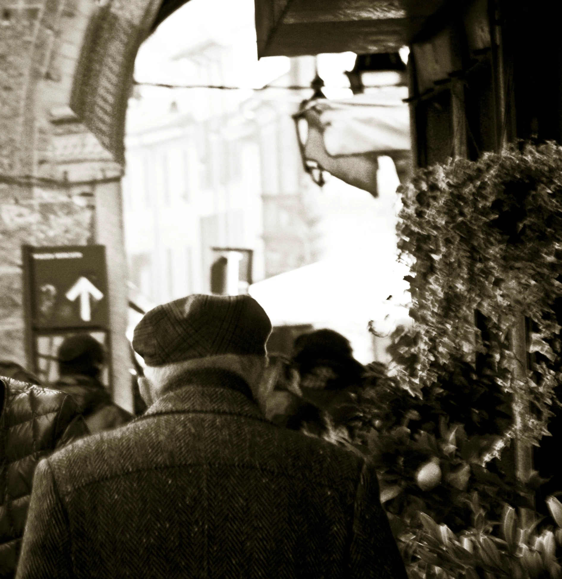 a black and white po of a man walking down the street