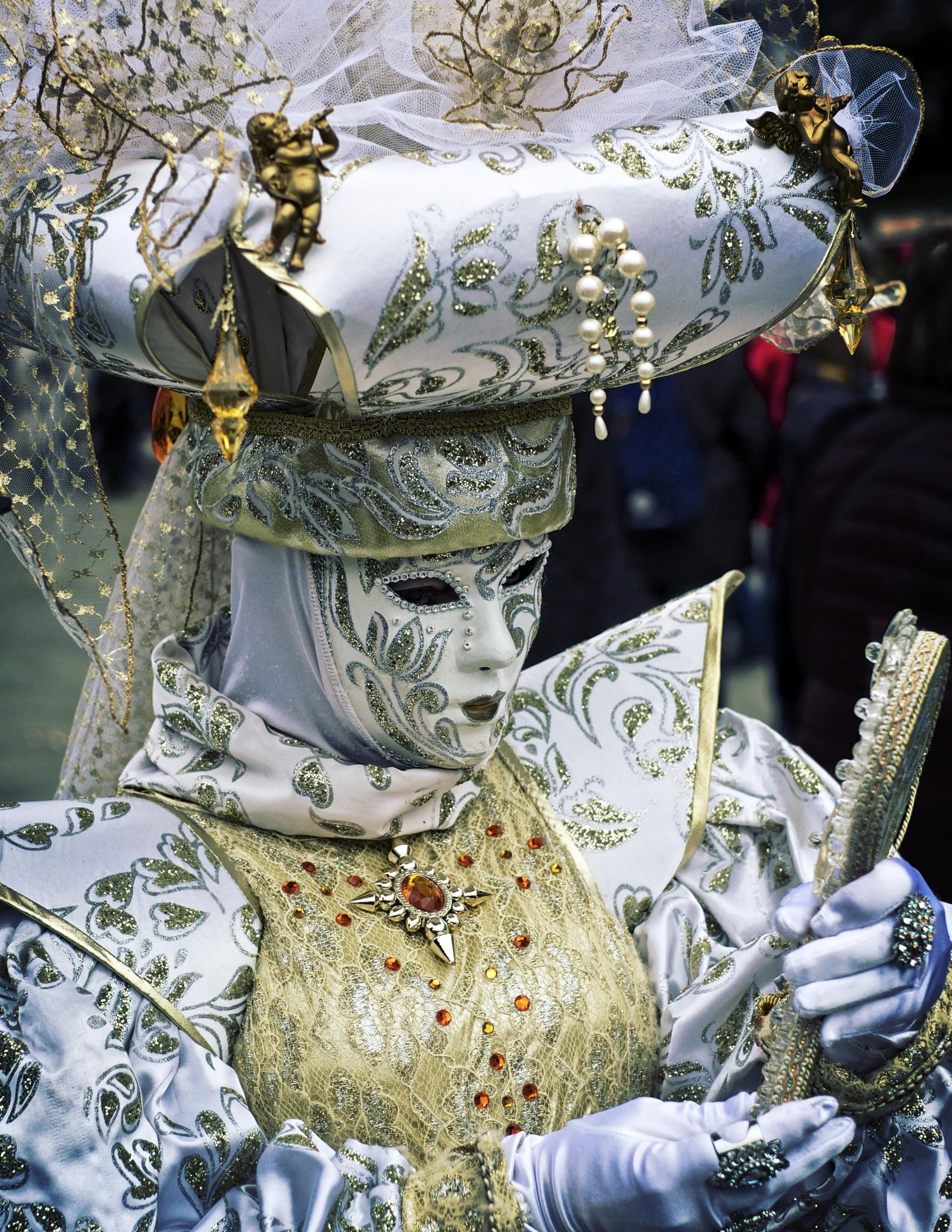 a costumed man dressed in fancy clothes holding a golden key