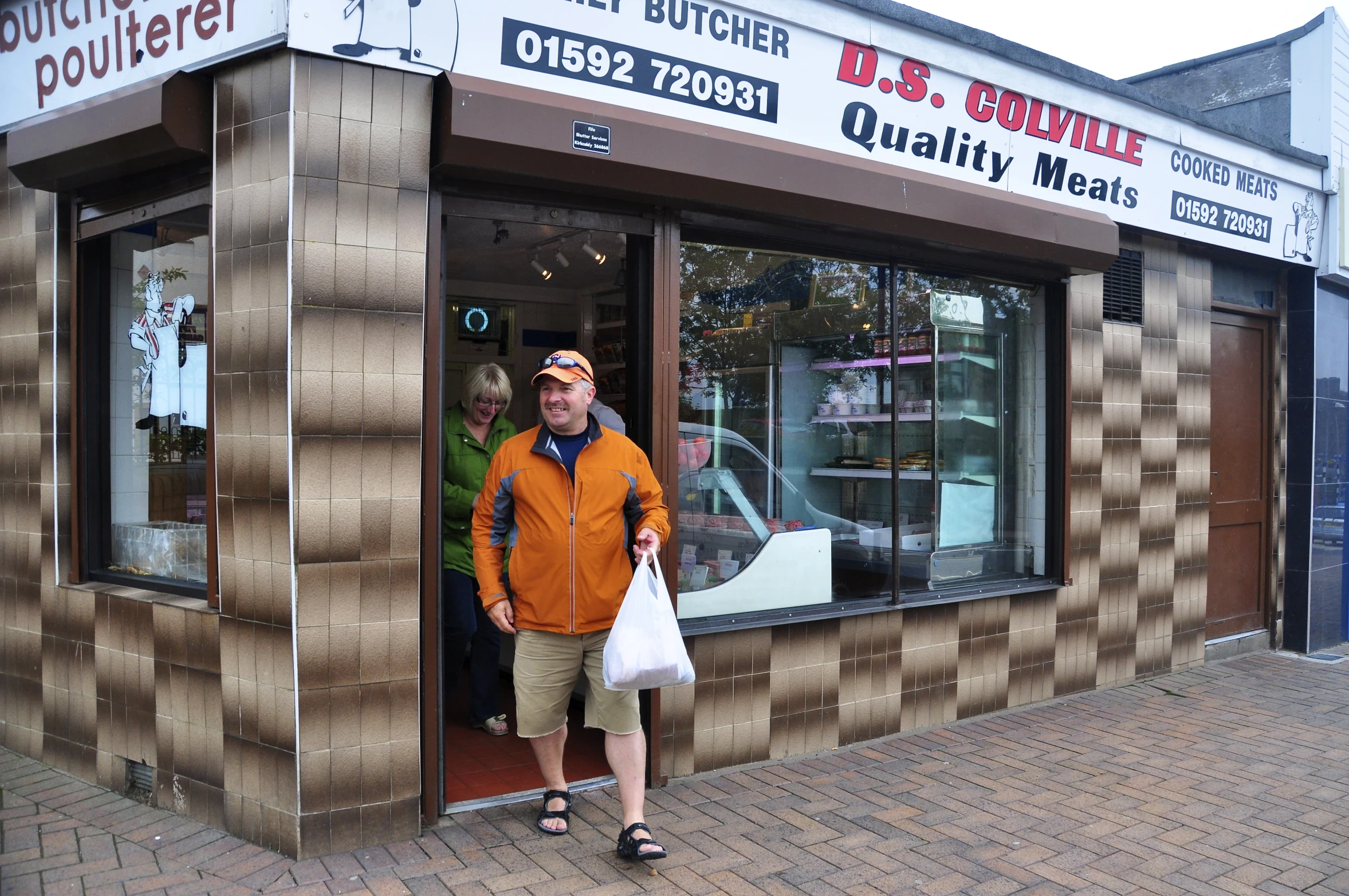 a man standing at the entrance of a store