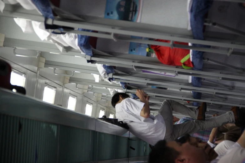 two people standing on top of bunk beds