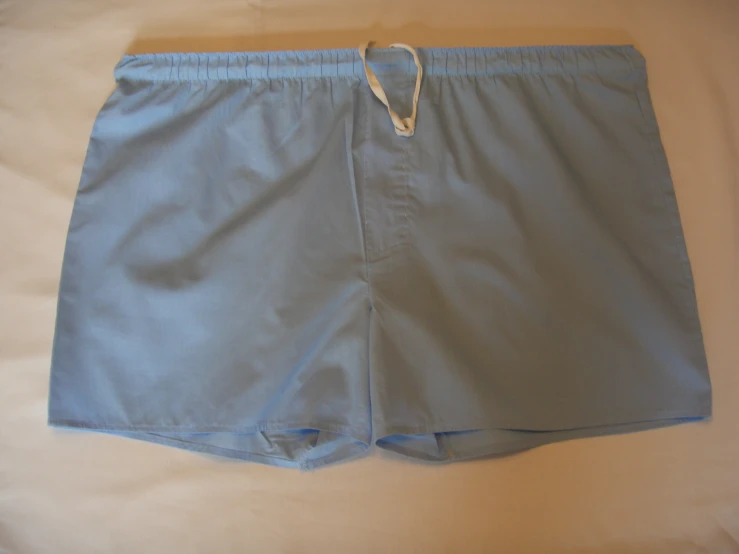 a women's shorty shorts, in blue, with string tied to the ankles and hem