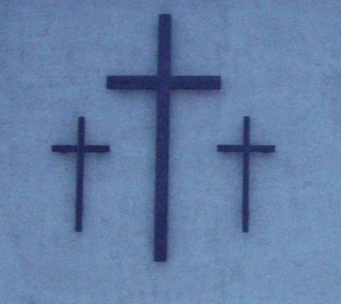 three cross mounted to the side of a wall