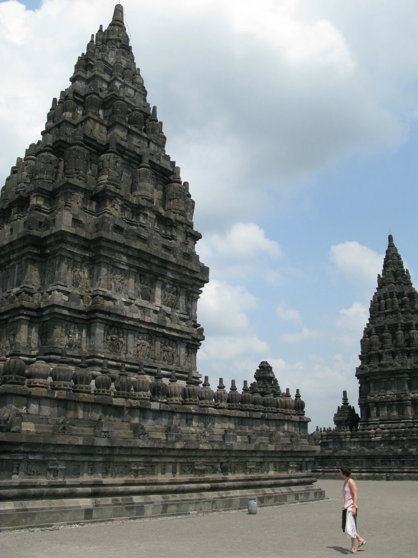 a tall ornate looking tower with many statues on the top