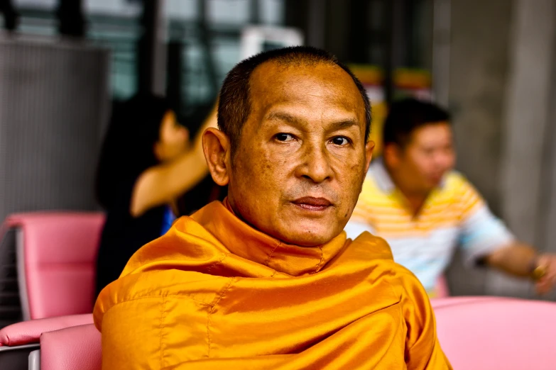a buddhist man who is wearing a yellow shawl