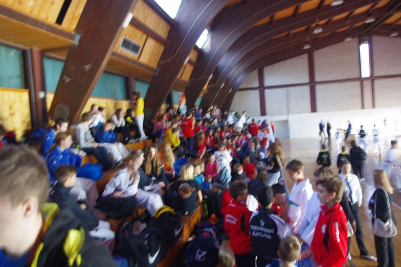 a large group of people in a wooden room