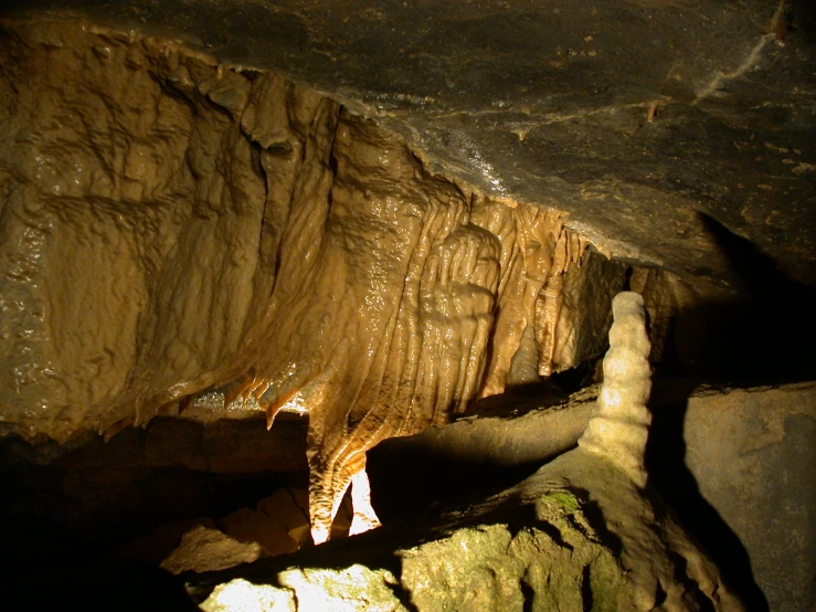 a view of the inside of a cave with light shining through