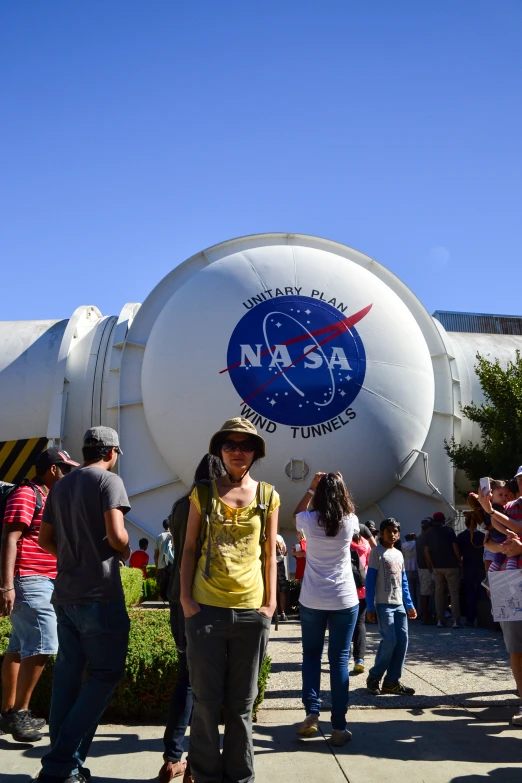 a man standing in front of a giant vehicle at an outdoor event