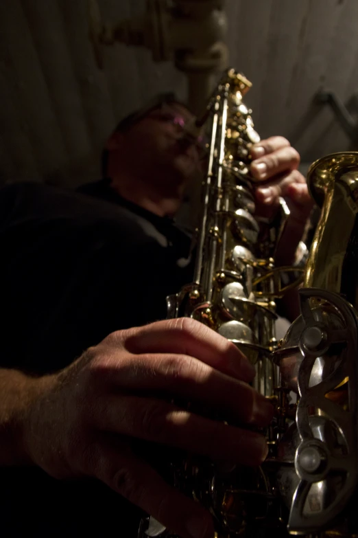 two men are playing musical instruments in a dark room