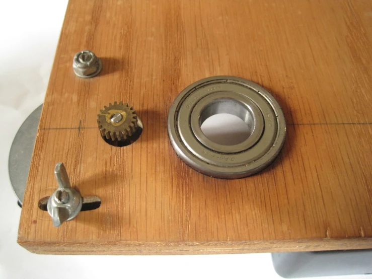 closeup of a metal mounted item with wooden board