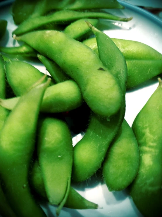 green beans are being stirred by a spoon